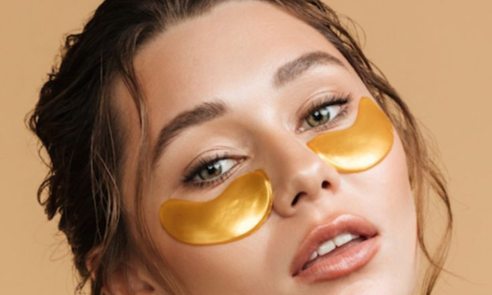 Woman wearing gold under-eye gel patches