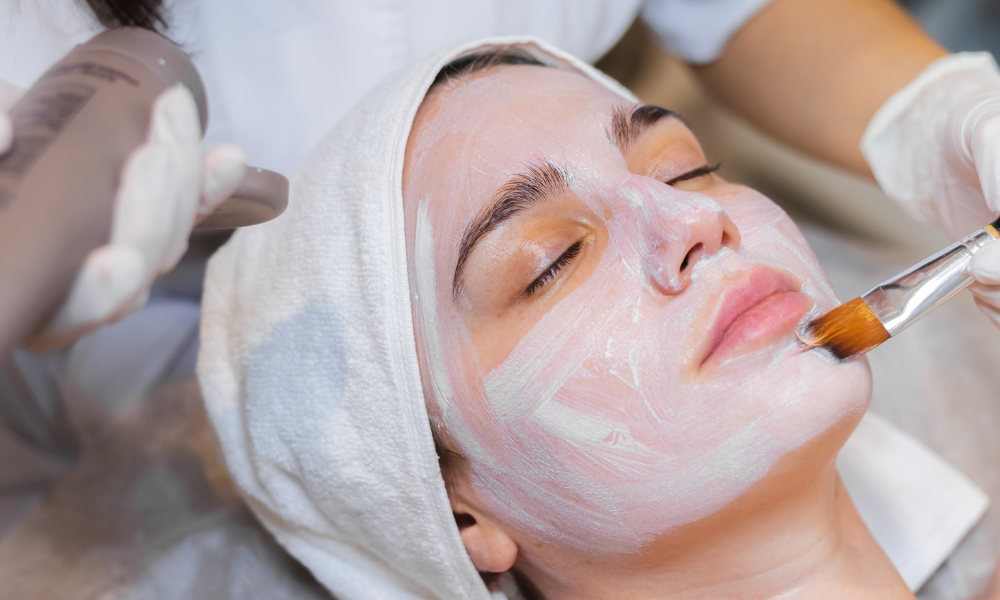 A person receiving a medical facial treatment at a clinic